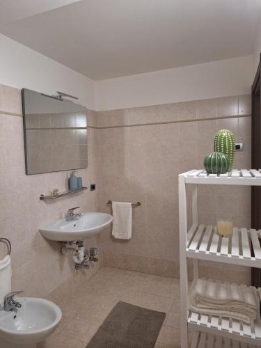 a bathroom with a sink and a mirror at appartamenti ACTIVESTAY in Arco