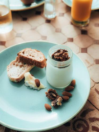 a plate with a jar of nut butter and bread at Hotel Mas Des Barres in Saintes-Maries-de-la-Mer