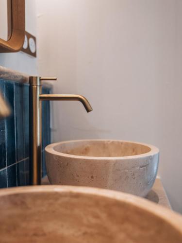 a bathroom sink with a copper faucet at Hotel Mas Des Barres in Saintes-Maries-de-la-Mer