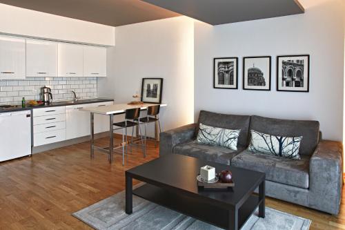 a living room with a couch a table and a coffee table at Apartman Istanbul in Istanbul