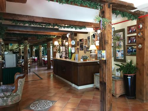 a bar in a restaurant with wooden beams at Hotel Cà Fiore in Bardonecchia