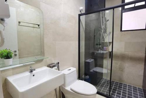a bathroom with a sink and a toilet and a shower at Muji style The Cove Ipoh in Ipoh