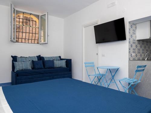 a living room with a couch and a table and chairs at De Vivo Realty - Camilla House Positano in Positano