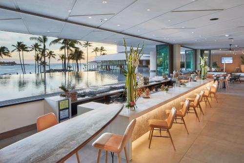 a bar in a hotel with a view of the ocean at The Ritz-Carlton O'ahu, Turtle Bay in Kahuku