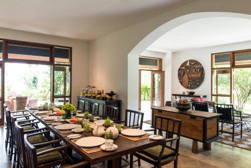 a large dining room with a long table and chairs at Stone House, Kandy in Kandy