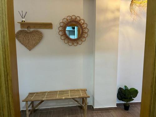 a room with a bench and a mirror on a wall at Sea City Torremolinos Beach in Torremolinos