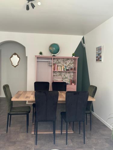 a dining room with a wooden table and chairs at Appartement plein centre du puy en velay avec parking in Le Puy en Velay