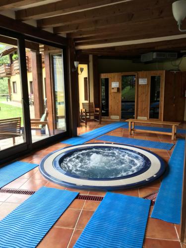 a hot tub in the middle of a room with blue mats at Hotel Cà Fiore in Bardonecchia