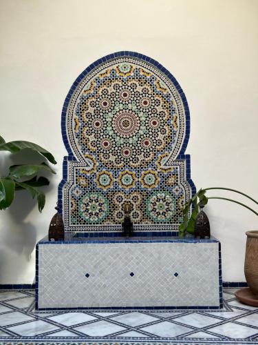 a blue and gold mosaic picture on a table at Dar Faracha Fes in Fès