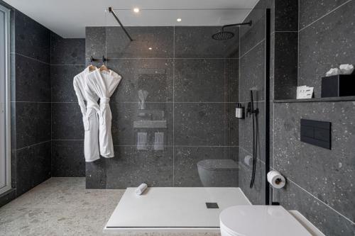 a bathroom with a shower with a toilet and a sink at Hotel Mistral St Julian's, Affiliated by Meliá in St Julian's