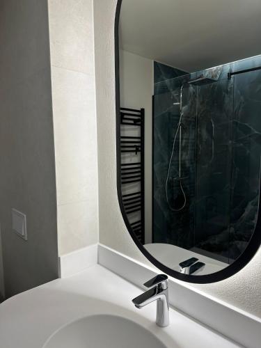 a bathroom with a sink and a mirror at Element in Alba Iulia