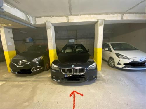 three cars are parked in a parking garage at Fl’Heurt de Mer appartement au pied de la plage, vue mer in Le Portel