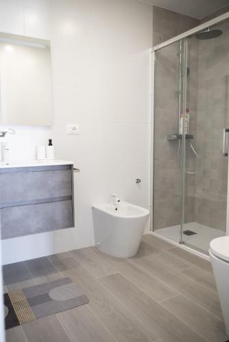 a bathroom with a toilet and a sink and a shower at Los Cristianos Aqua Viva in Los Cristianos