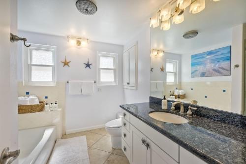 a bathroom with a sink and a tub and a toilet at Oceanfront Getaway, Private Beach, Fire Pit, 5BR in Oceanside