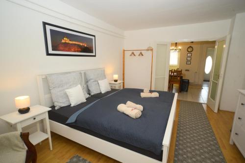 a bedroom with a large bed with two pillows on it at Vadrózsa apartman in Sümeg