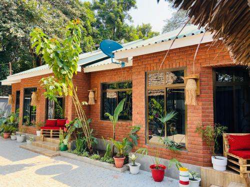 a brick house with plants in front of it at Villa Rosa in Moshi