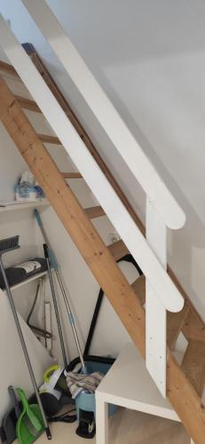 a staircase in a room with wooden ceilings at Le petit Treguier in Tréguier