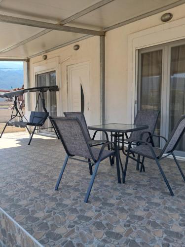 a patio with a table and chairs on a house at Four Seasons in Leptokaria
