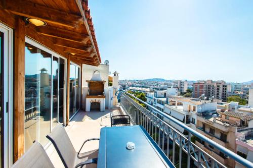 a balcony with a blue table and chairs on a building at Lis153 by Smart Cozy Suites - Top Floors with Amazing City View - Available 24hr in Athens