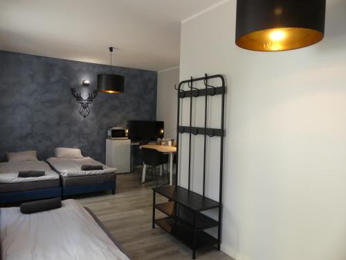 a bedroom with a bed and a desk with a table at Studio Centrum in Tarnobrzeg