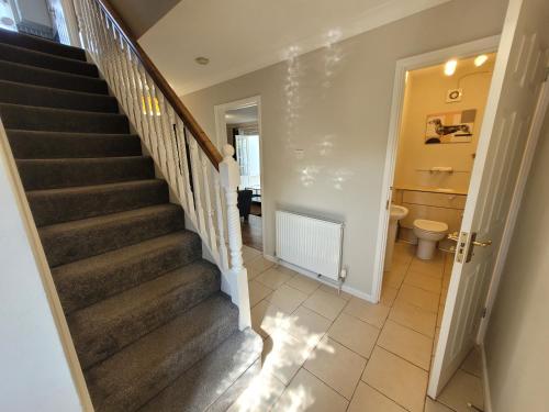 a staircase in a house with a toilet at President Road- A Spacious and homely four bed house by Catchpole Stays in Lexden