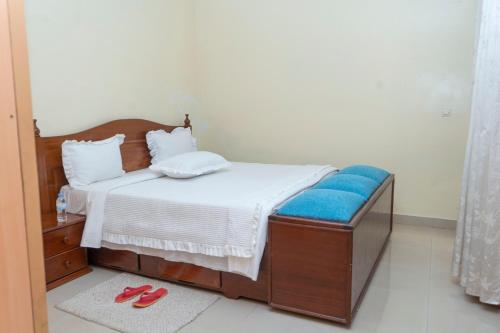 a bedroom with a bed and a pair of red shoes at Kigali Green View Apartments in Kigali