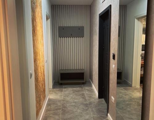 a hallway with two doors and a tile floor at MONARC Boutique ApartHotel - SELF CHECK-IN in Iaşi