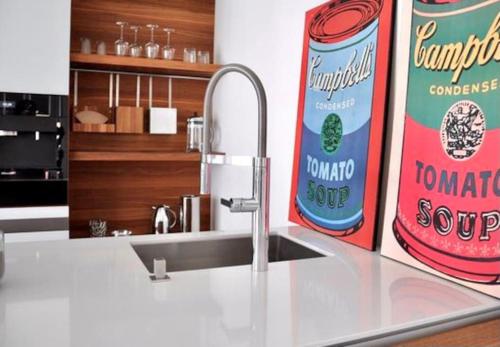 a kitchen counter with a sink and a can of tomato sauce at SH-Apartment Penthouse 44 - zentral & einzigartig in Erfurt