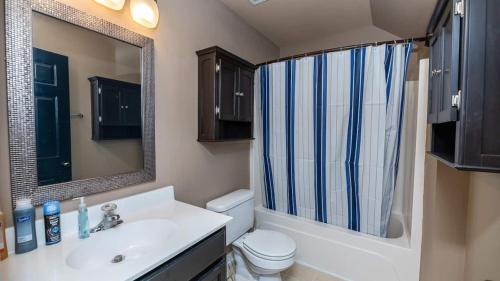 a bathroom with a sink and a toilet and a mirror at Charming, Spacious, Ideal 4 Groups Near Charleston in Charleston