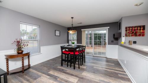a kitchen and dining room with a table and chairs at Charming, Spacious, Ideal 4 Groups Near Charleston in Charleston