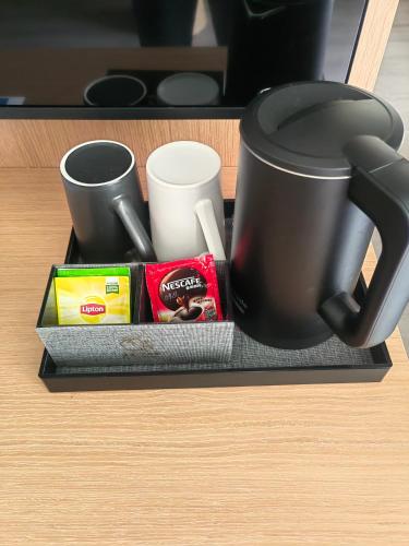 a tray with a coffee mug and other items on it at Yangshuo-Greenery Retreat in Yangshuo