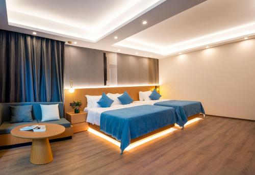 a hotel room with a bed and a couch at Yangshuo-Greenery Retreat in Yangshuo