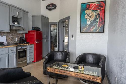 a kitchen with two chairs and a table in a room at Willie In the Hill Country - Hacienda Amor in Johnson City