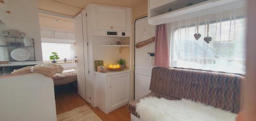 a living room with a couch and a window at übernachtung in unserem Wohnwagen in Gračac