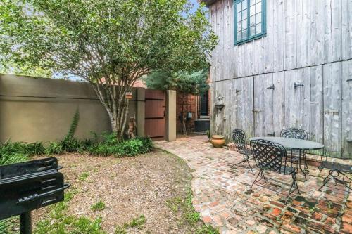 a patio with a table and chairs next to a building at Historic Old Bank with Vault in Downtown Scott in Scott