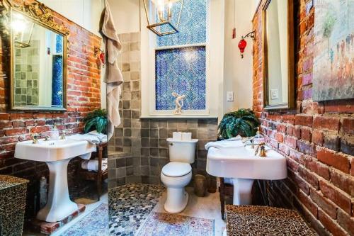 a bathroom with two sinks and a toilet at Historic Old Bank with Vault in Downtown Scott in Scott