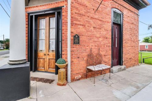a fire hydrant sitting outside of a brick building at Historic Old Bank with Vault in Downtown Scott in Scott