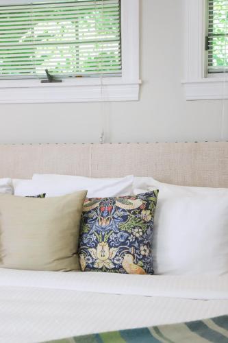 a white couch with two pillows and a window at Hartstone Inn in Camden