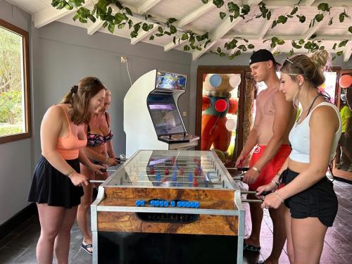 a group of people standing around a table with a video game at Marhaba Salem - Family Only in Sousse