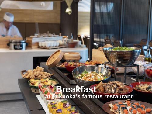 a buffet with many different types of food on a table at Mitsui Garden Hotel Fukuoka Nakasu in Fukuoka