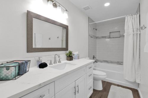 a bathroom with a sink and a toilet and a mirror at Sunlit Serenity in Tempe in Tempe