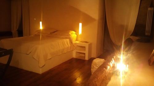 a bedroom with a bed and two lights on the floor at Posta Santa Croce in Bisceglie