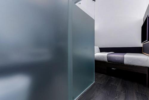 a sliding glass door in a room with a bed at The Z Hotel Holborn in London