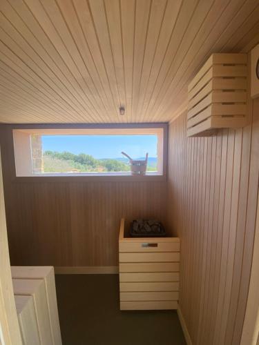 a small room with a window and a wooden wall at Podere Cavalbianco in Ciggiano