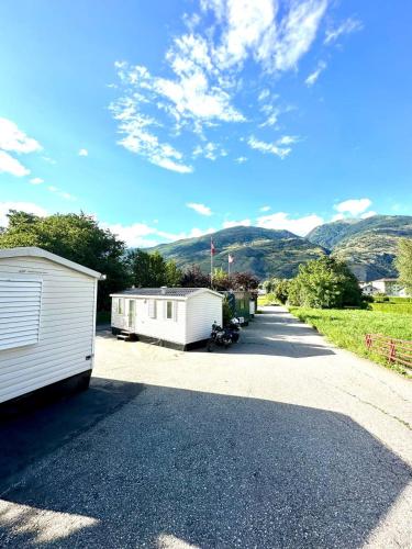 two white trailers parked on the side of a road at Cottage 1 in Agarn