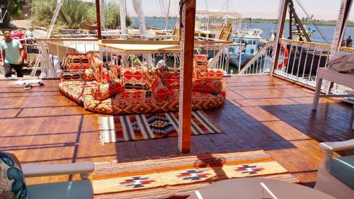 a deck of a boat with two beds on it at Cinderella Malika in Al Bayāḑīyah
