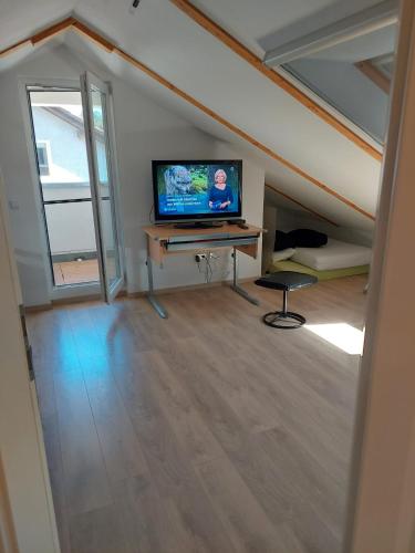 a living room with a flat screen tv in a attic at Prinz in Weinheim