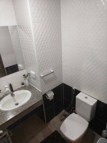 a bathroom with a white toilet and a sink at Beach condo Jomtien 12 SuperHost in Jomtien Beach