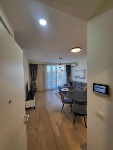 a living room with a table and a dining room at BW Waterfront LUX apartment, parking free in Sajmište