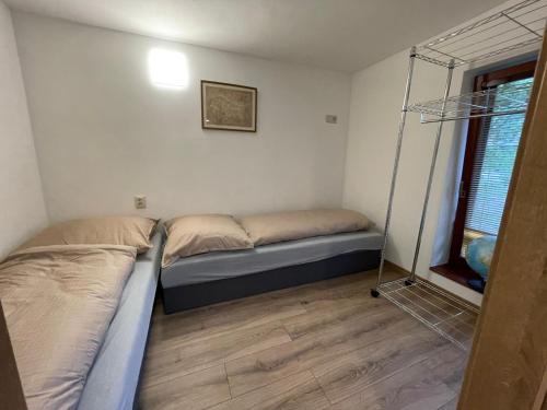 a small bedroom with two beds and a window at Apartmány Kašper in Levoča